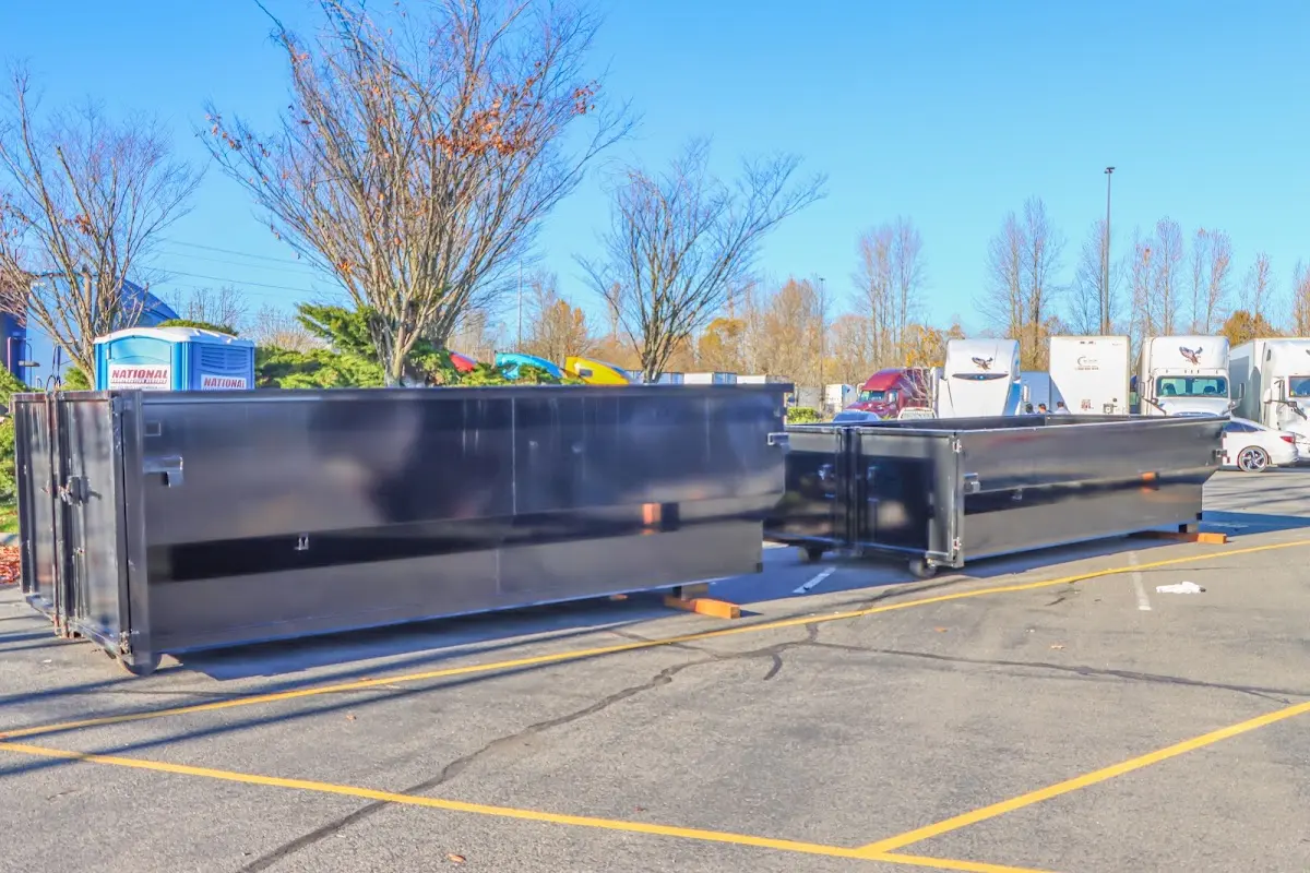 Professional dumpster rental service with roll-off container on residential driveway in Benbrook
